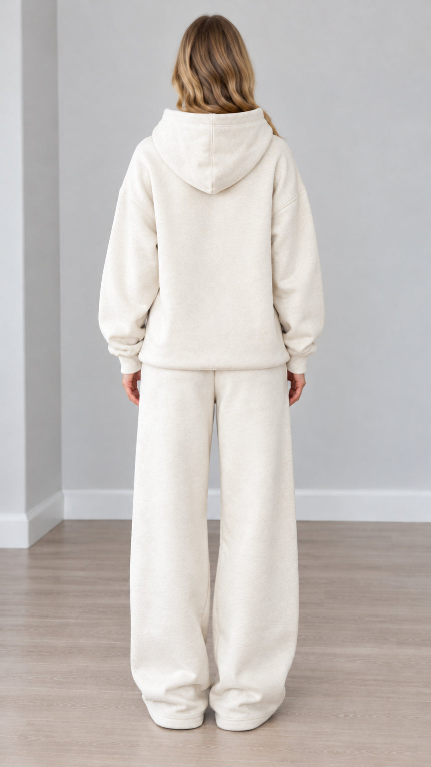 Back view of woman wearing cream oversized hoodie and wide-leg loungewear pants
