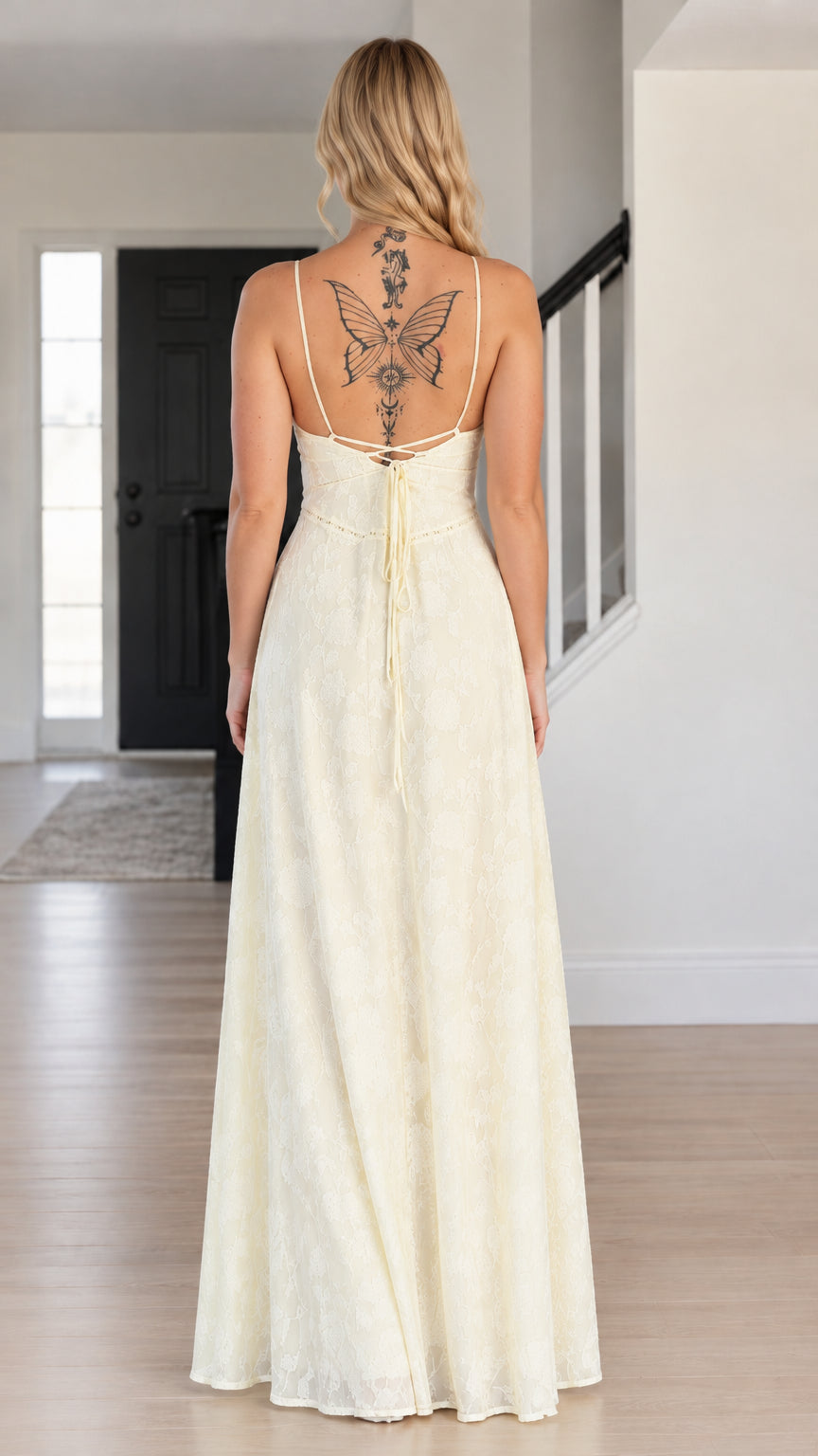 Back view of woman showing lace-up open back detail on ivory maxi dress