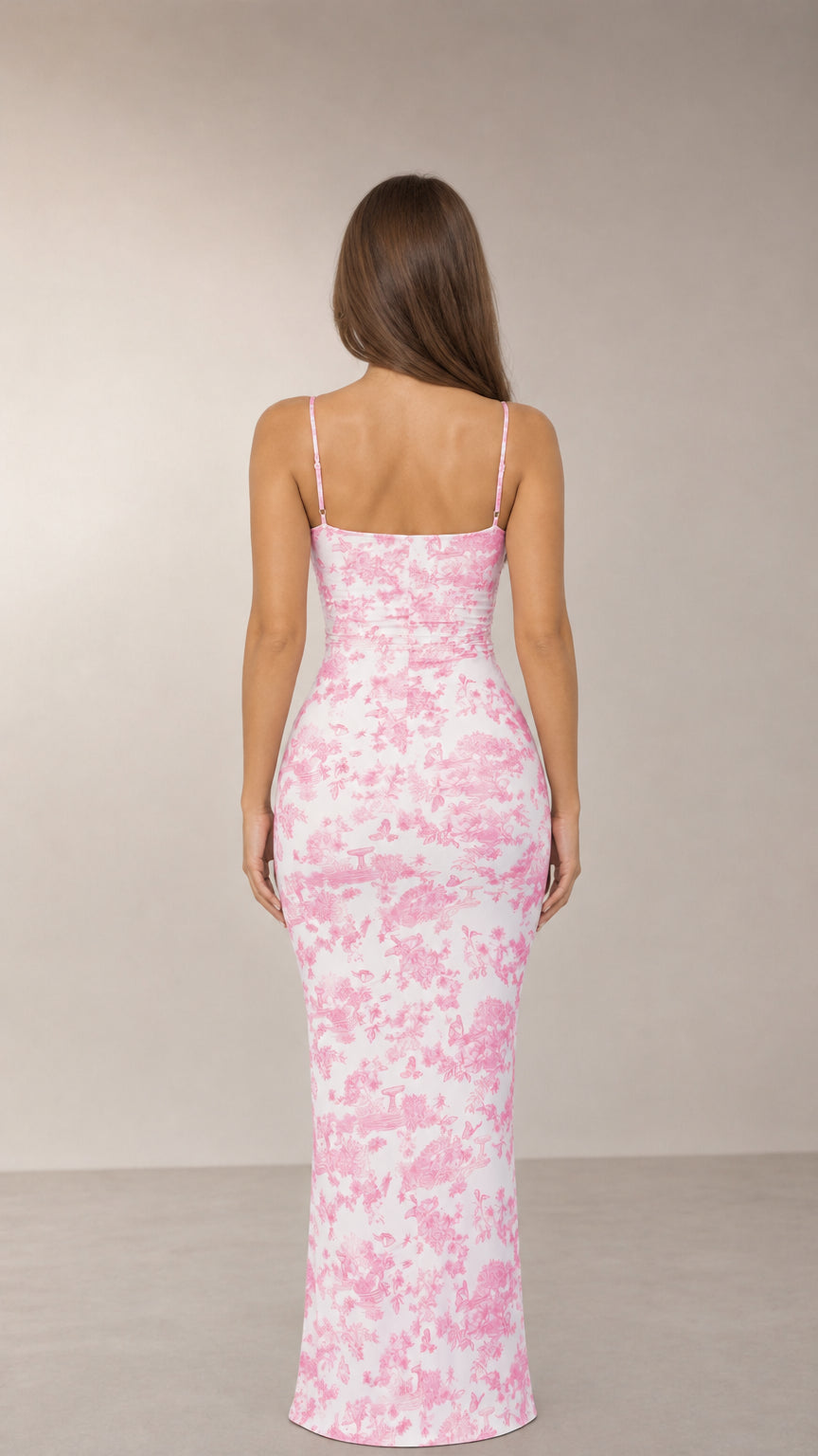 Back view of model wearing pink toile print maxi dress with slim straps