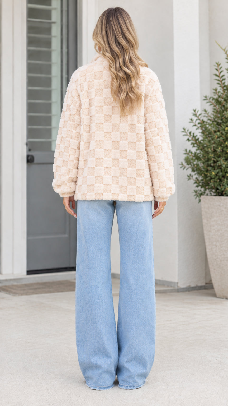 Back view of model wearing beige checkerboard plush fleece jacket