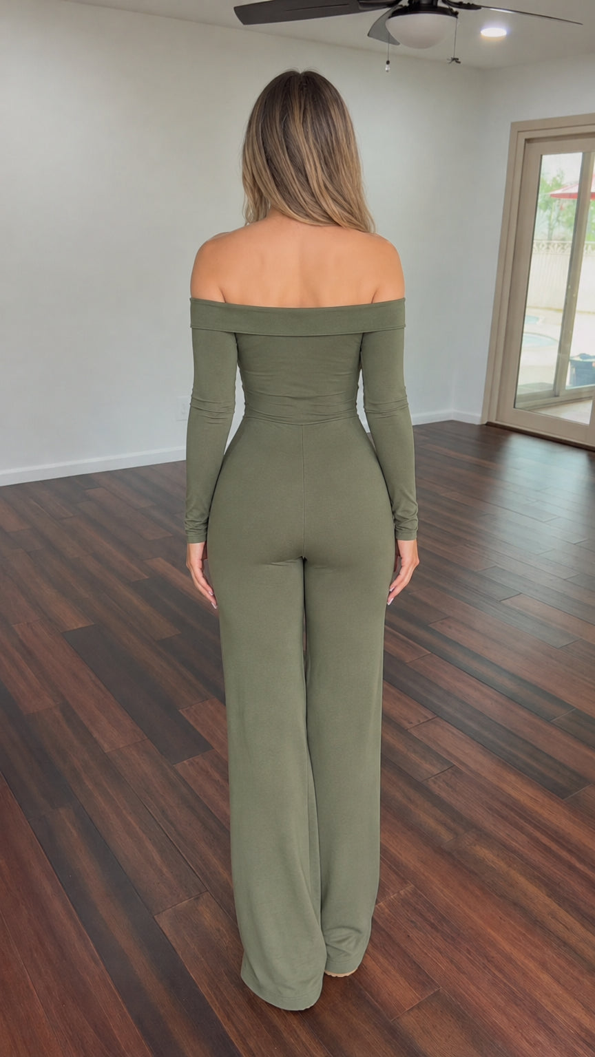 Model wearing sage green off-the-shoulder long sleeve wide-leg jumpsuit back view
