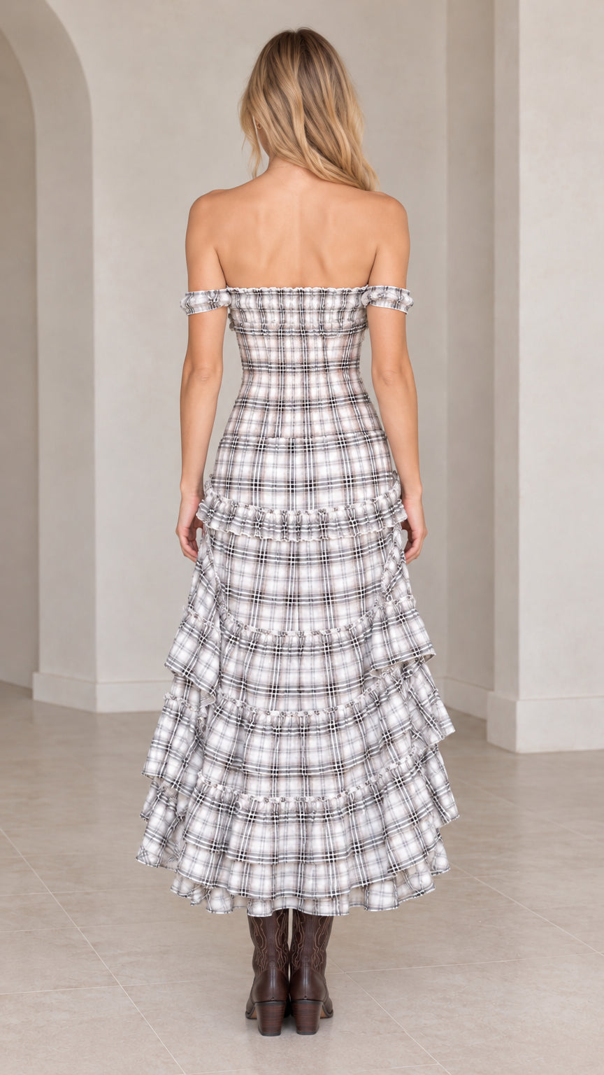 Back view of model wearing grey plaid off-the-shoulder tiered maxi dress showing smocked back