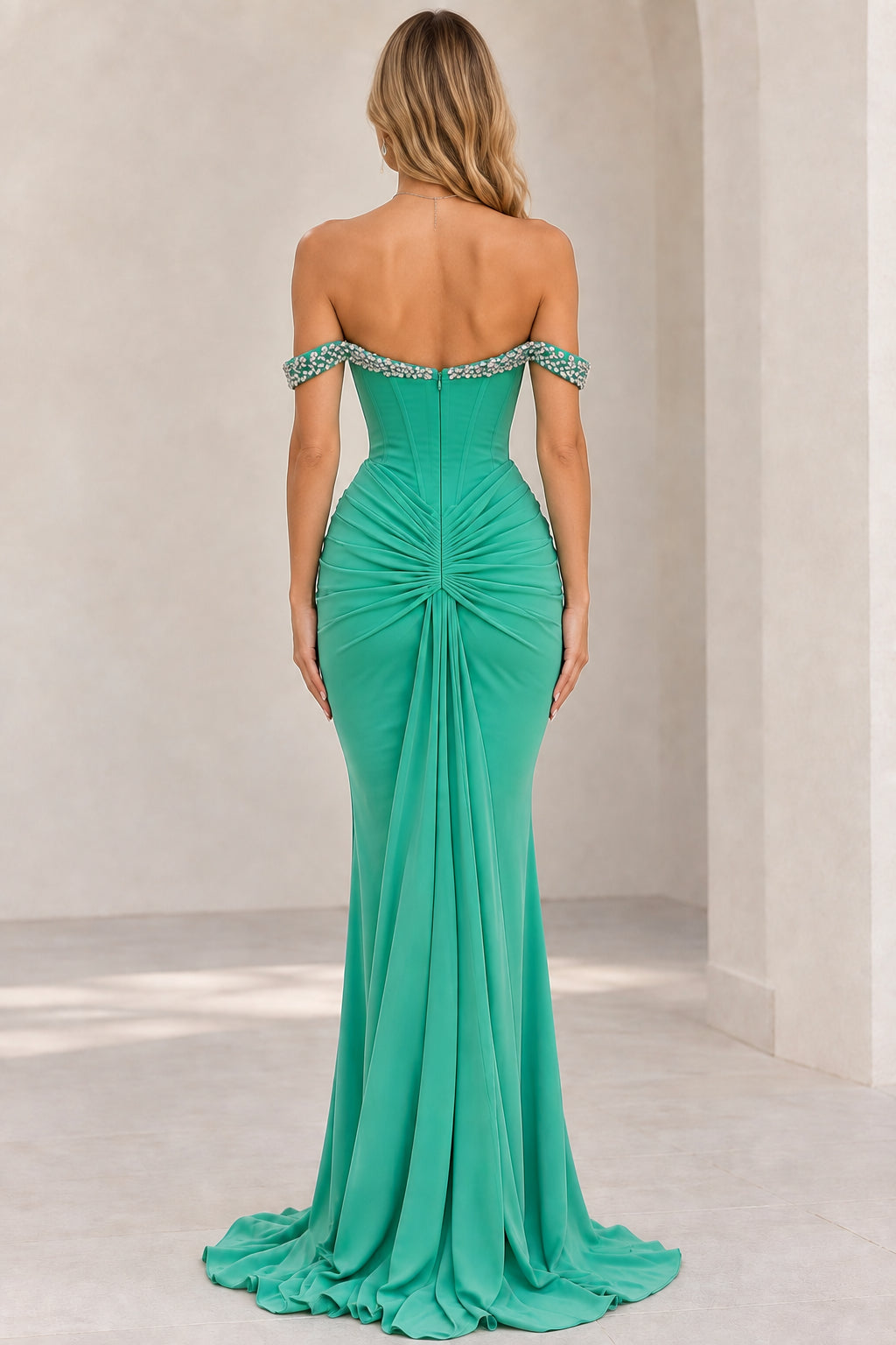 Back view of emerald green off-the-shoulder formal maxi dress showing ruched drape