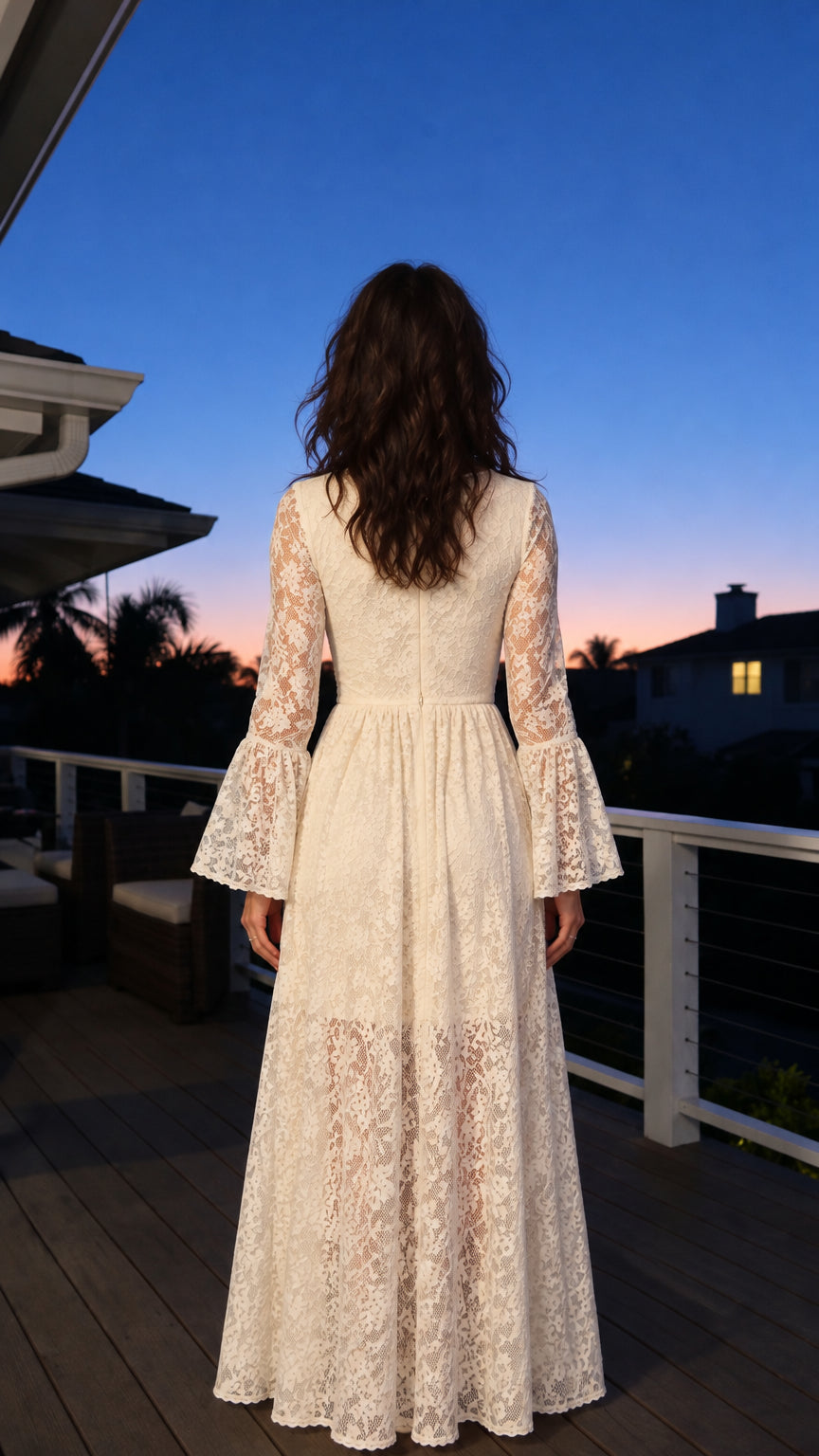 Back view of woman wearing ivory floral lace maxi dress showcasing sheer lace overlay