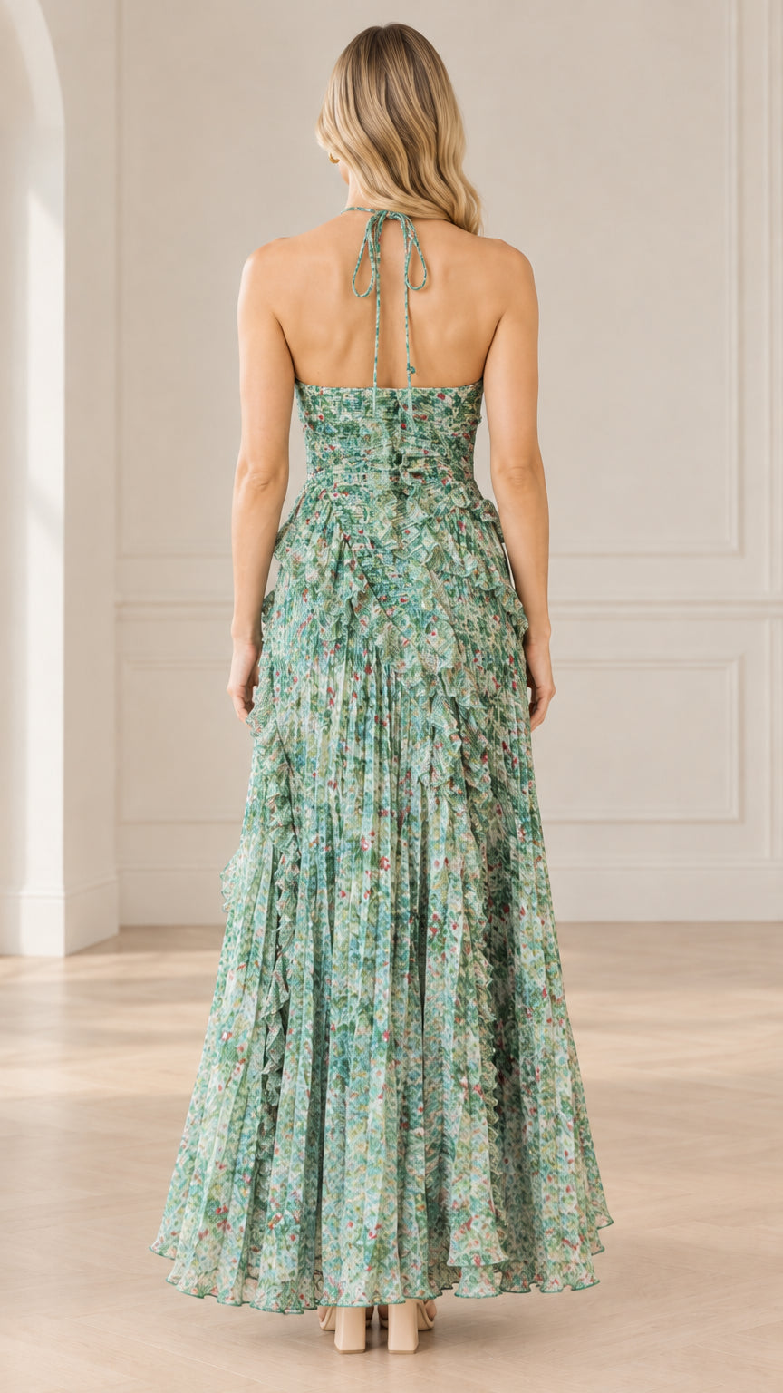 Back view of model in sage green floral halter maxi dress showing open back and tie neck