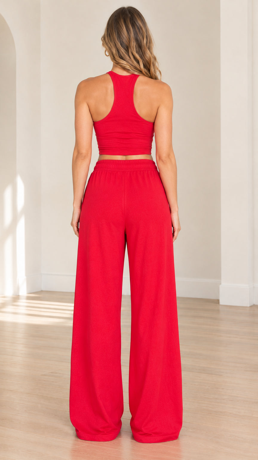Rear view of woman modeling the red racerback cropped tank and floor-length wide-leg pants