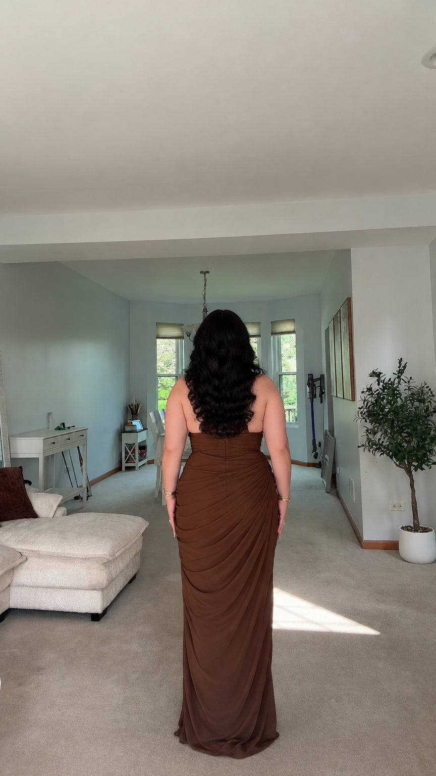 Back view of woman wearing brown open-back halter evening dress