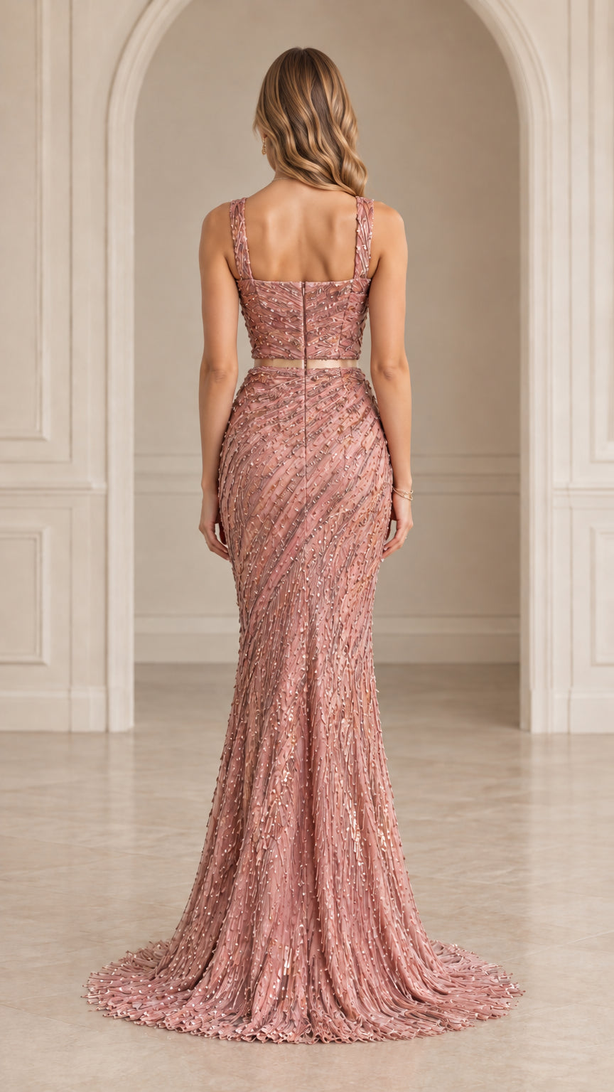 Back view of woman wearing dusty rose sequined gown showing back zip and train