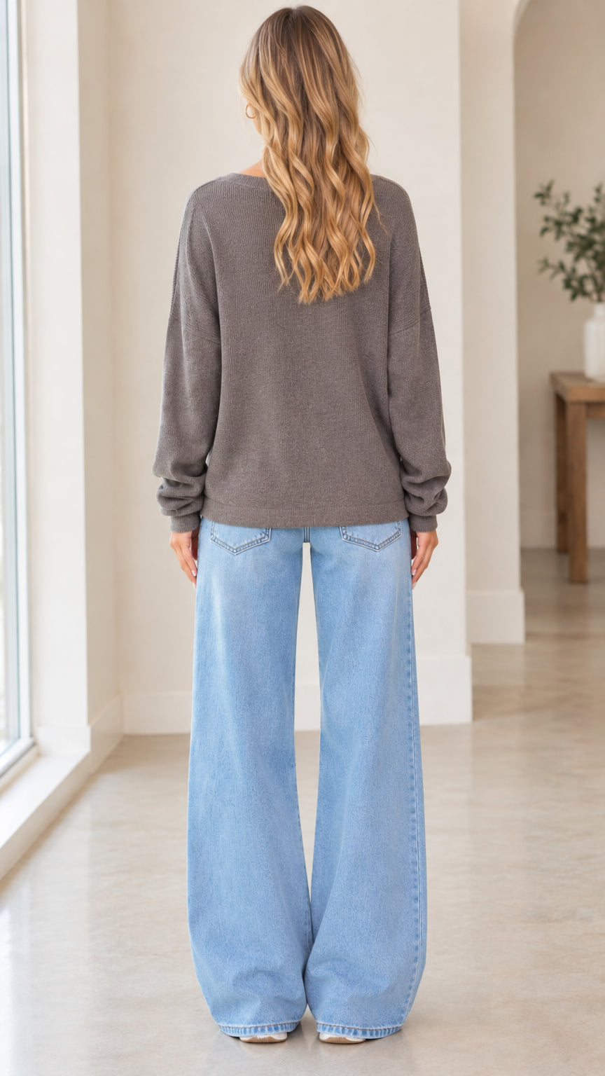 Back view of woman wearing charcoal grey crewneck knit pullover sweatshirt
