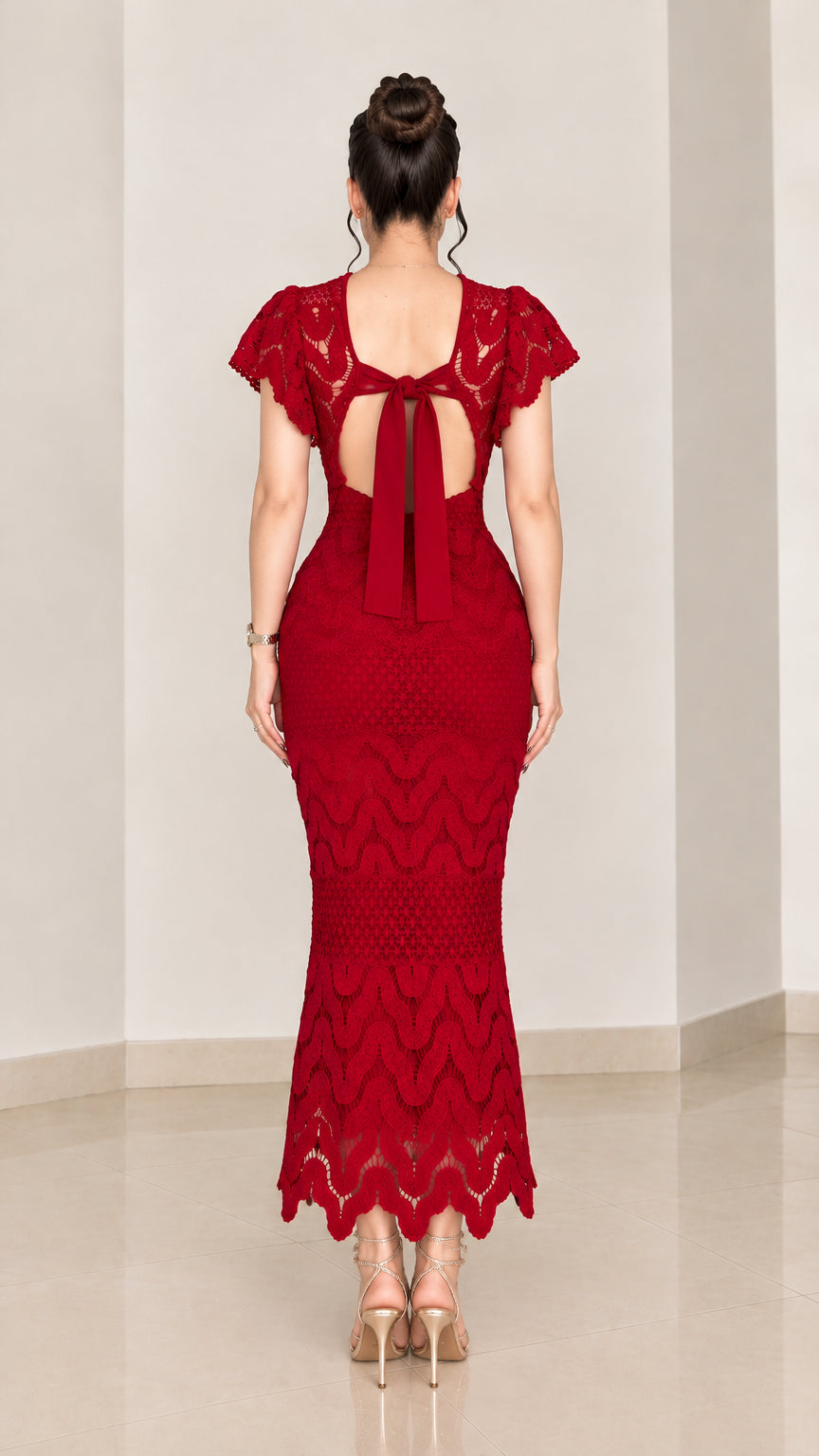 Back view of red lace mermaid dress highlighting back cutout and tie detail
