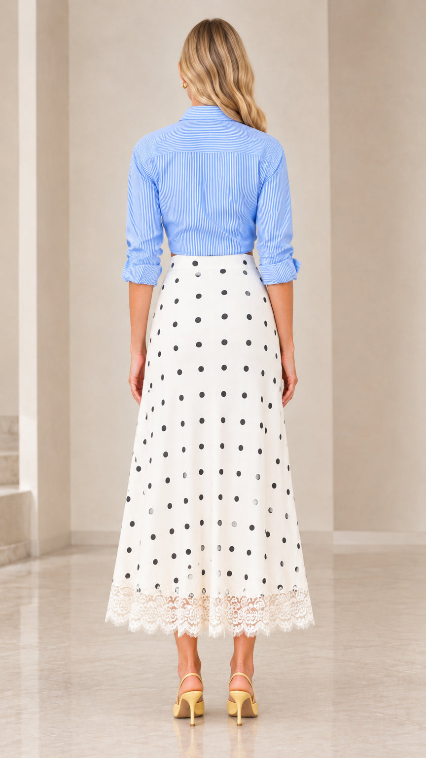 Back view of woman wearing blue striped button-up shirt and polka dot midi skirt