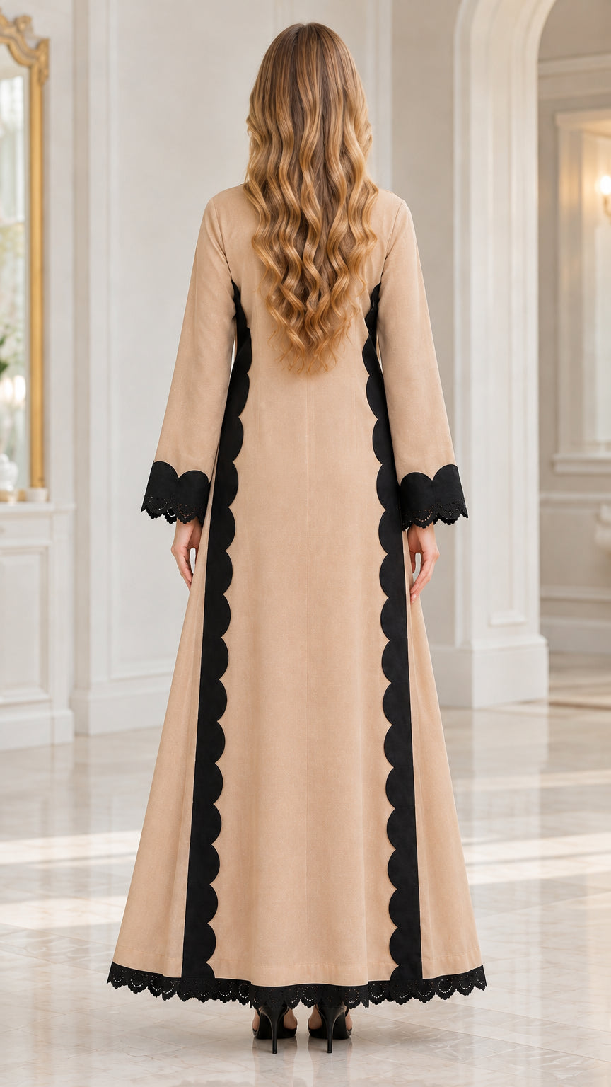 Back view of woman wearing beige longline tunic with black scalloped accents