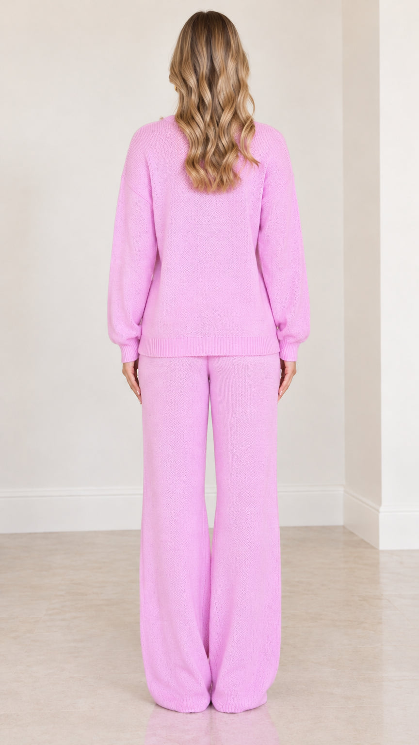 Back view of model wearing matching pink knit two piece set