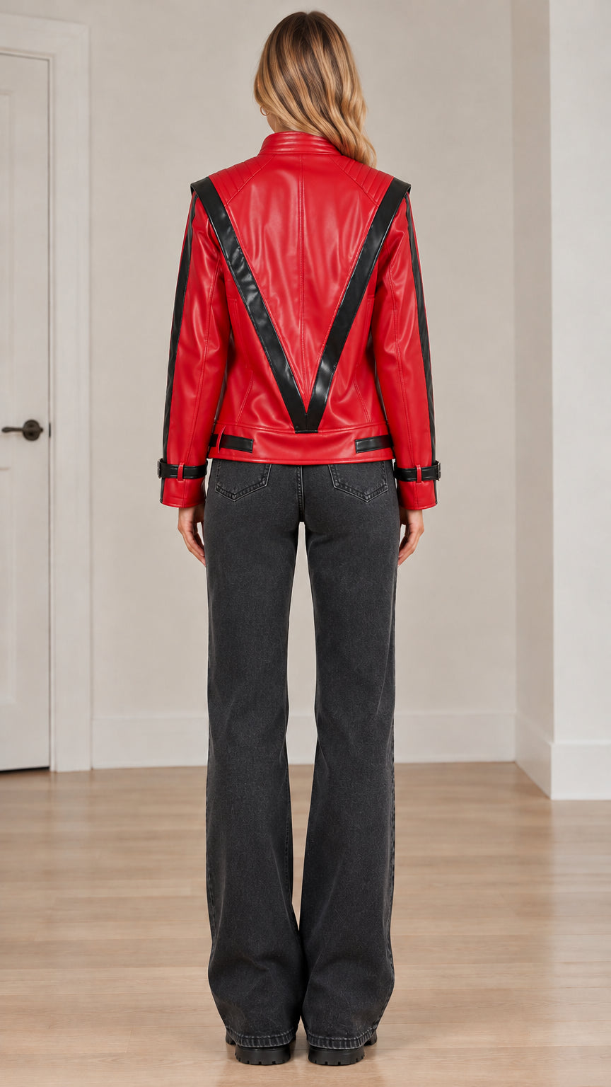 Back view of red faux leather jacket displaying prominent black chevron V-stripe pattern