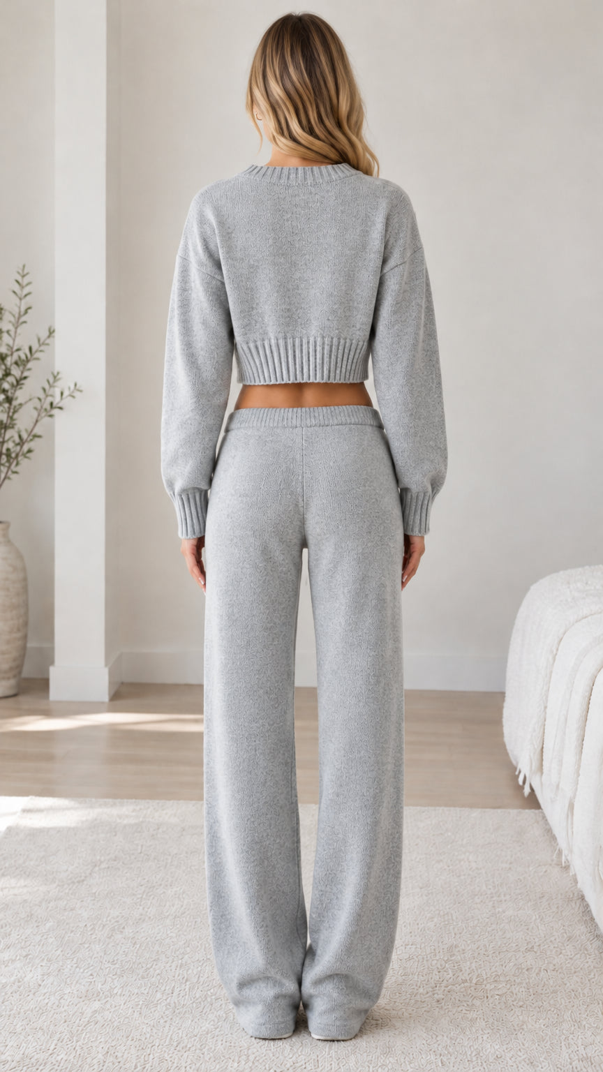 Back view of model wearing grey knit cropped sweater and matching wide-leg trousers