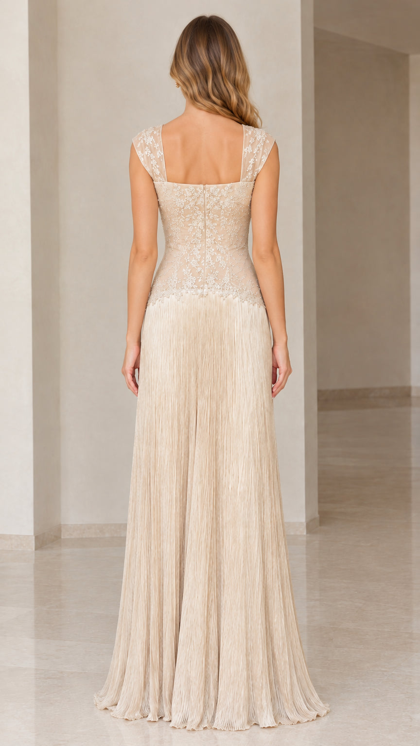 Back view of champagne formal gown showing square back neckline and floor-length fringe