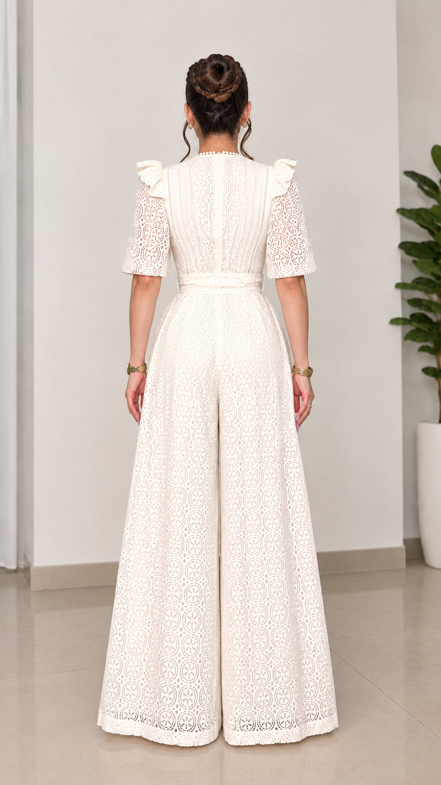 Back view of woman wearing ivory lace wide-leg jumpsuit with back zipper