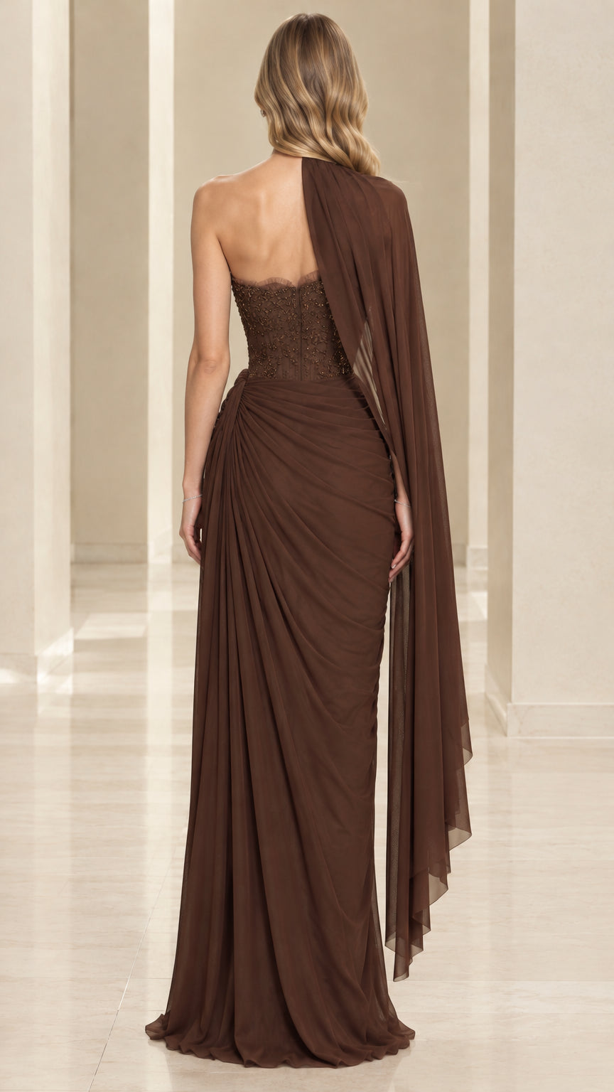 Back view of chocolate brown corset maxi gown with flowing shoulder drape