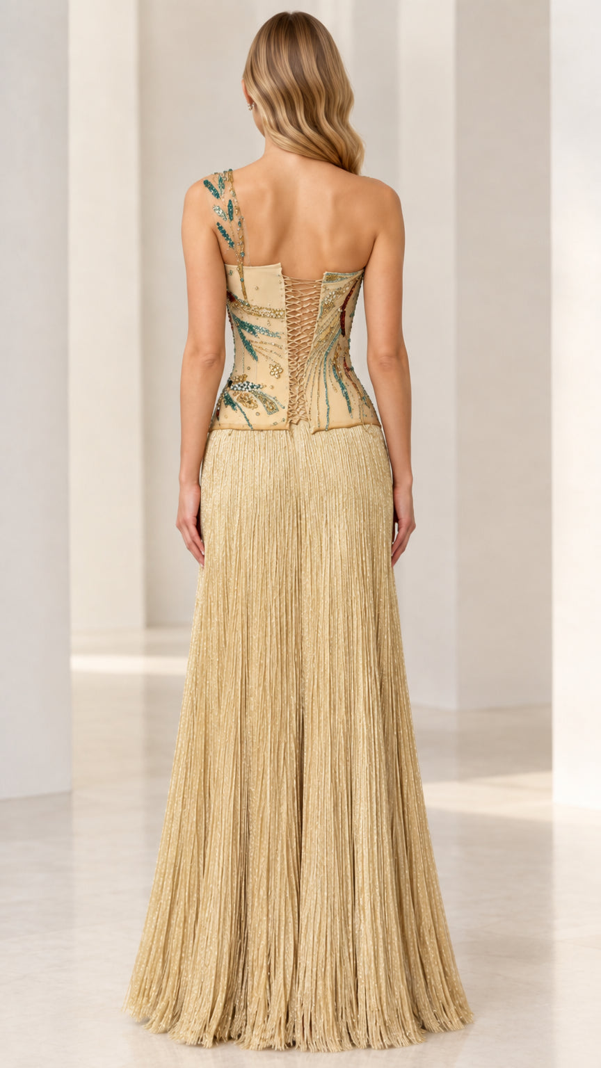 Back view of gold formal gown showing adjustable corset lace-up closure and long fringe skirt
