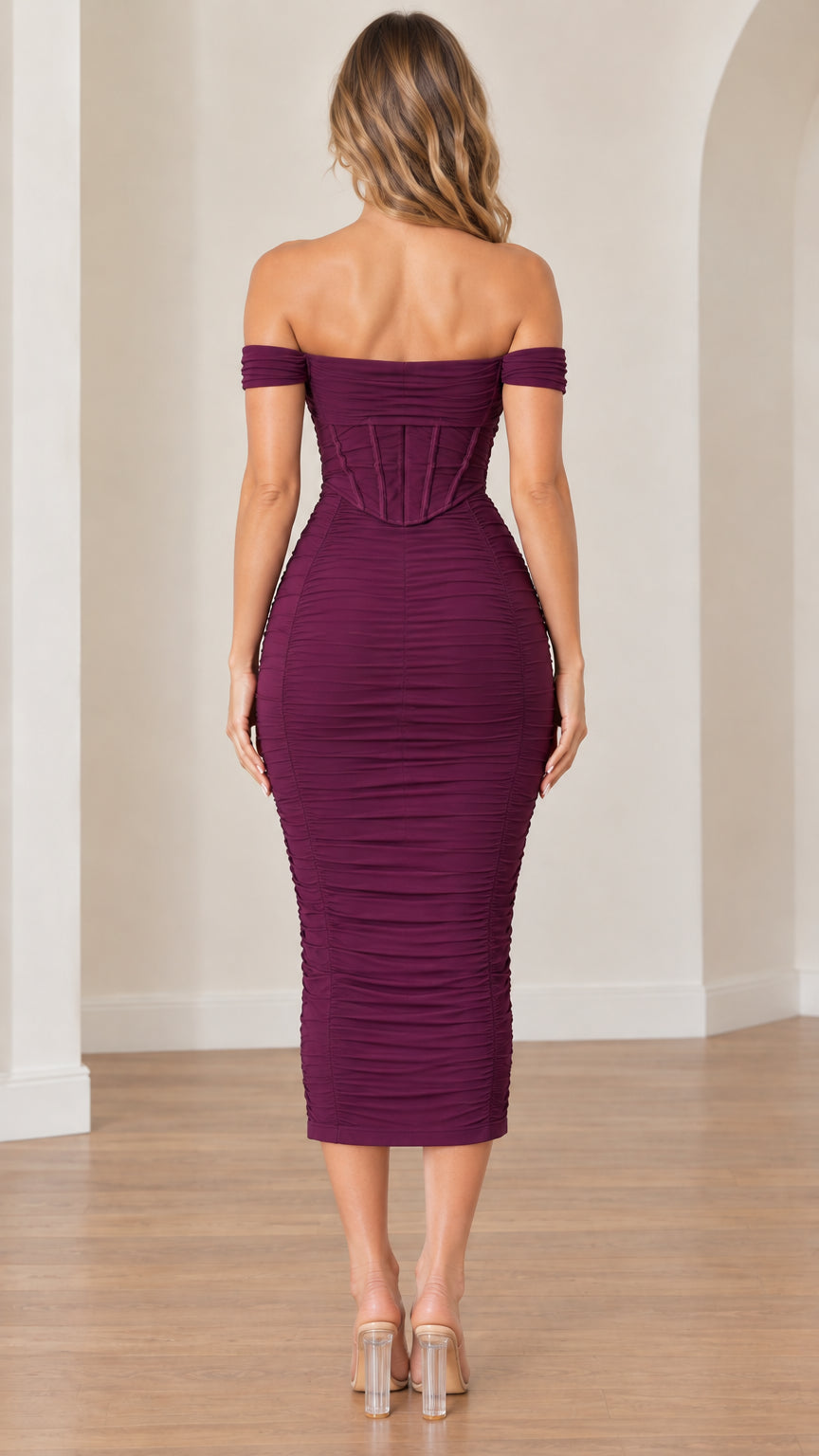 Back view of model wearing the plum off-the-shoulder ruched midi dress