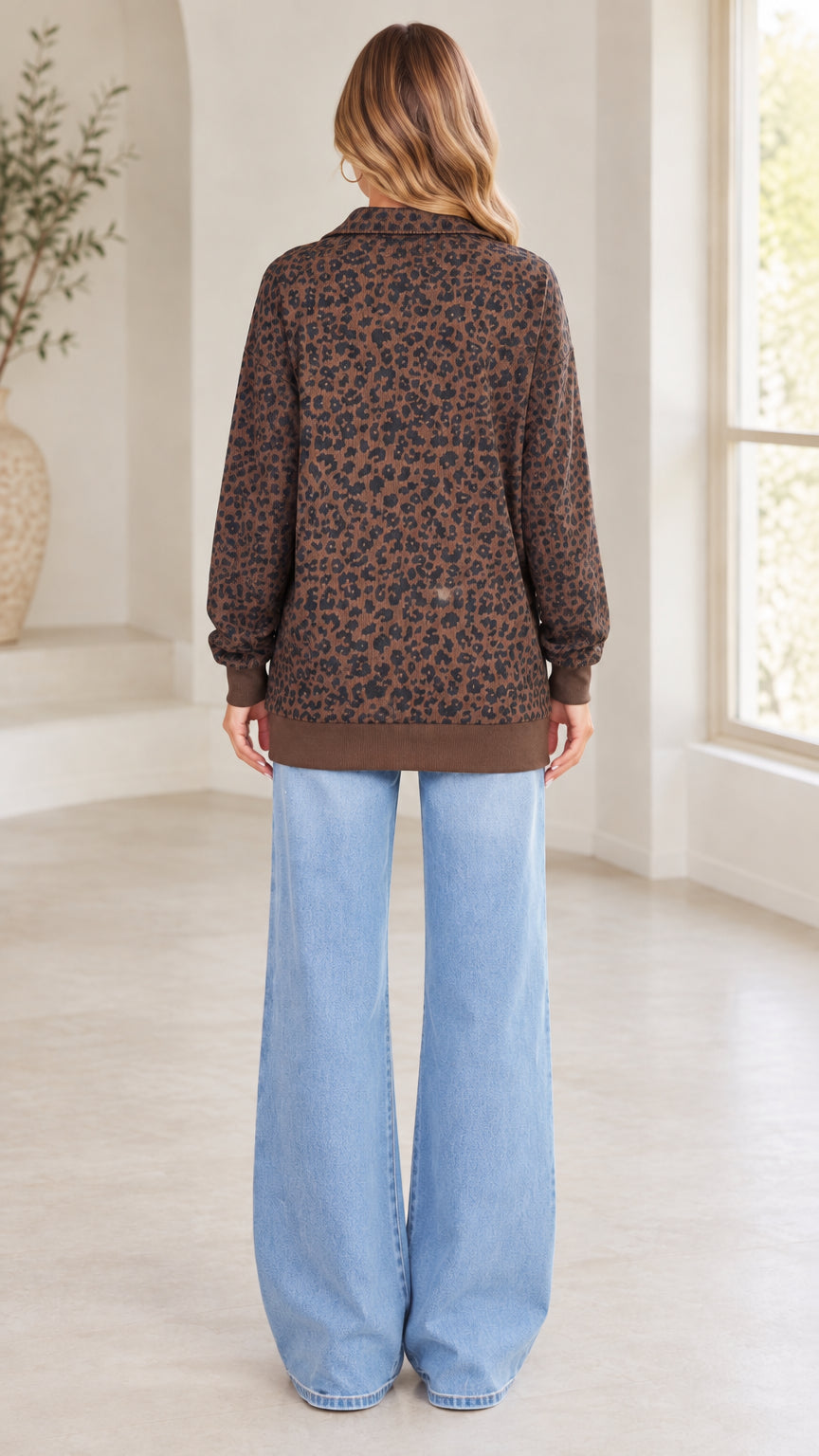 Back view of model wearing brown leopard print long sleeve quarter-zip sweatshirt