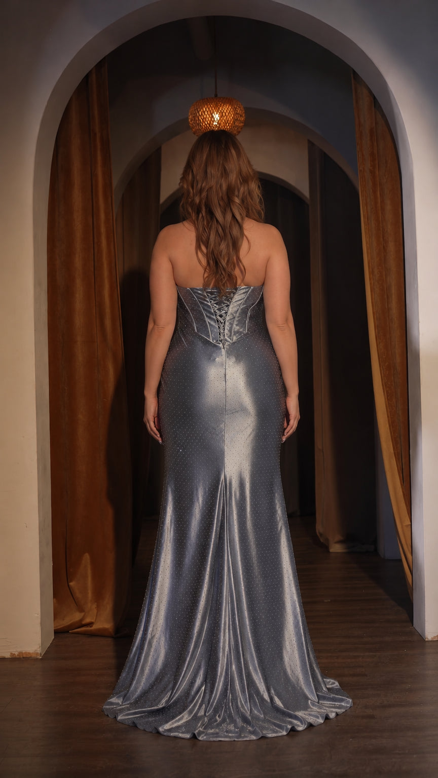 Rear view of slate blue shimmer evening gown displaying lace-up corset closure and train
