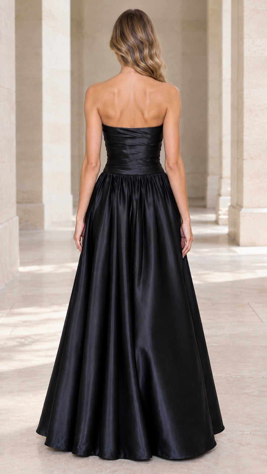 Back view of model in black strapless satin evening dress highlighting clean back bodice fit