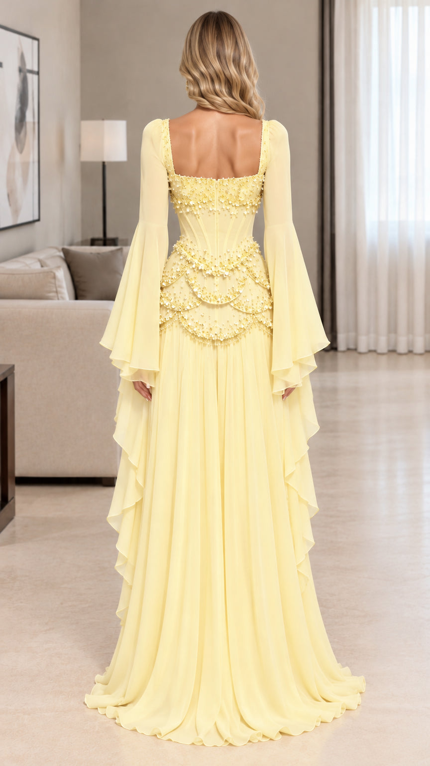 Back full-length view of yellow square neck corset evening gown showing dramatic draped sleeves