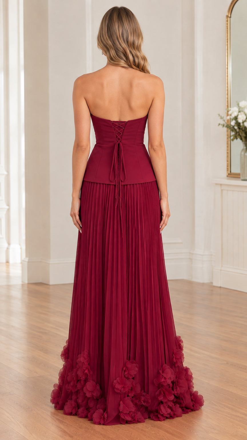 Back view of model displaying lace-up tie closure on burgundy strapless evening dress