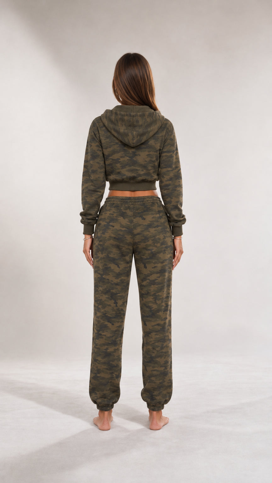 Back view of woman wearing olive green camo cropped hoodie and joggers