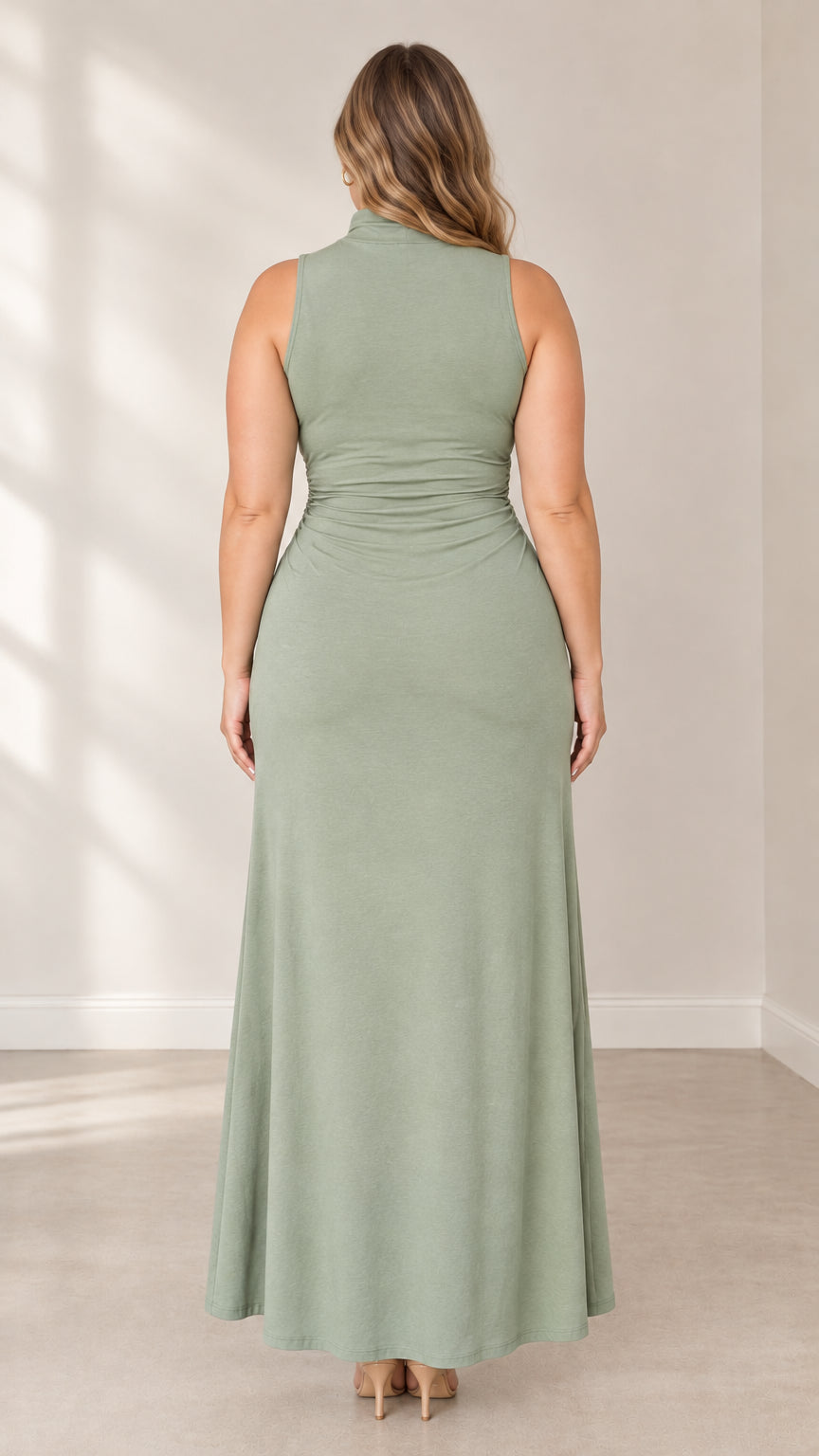 Back full-length view of woman in sage green high neck sleeveless maxi dress