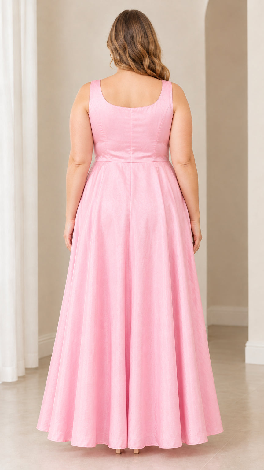 Back view of woman wearing pink scoop back A-line maxi gown showing waistline