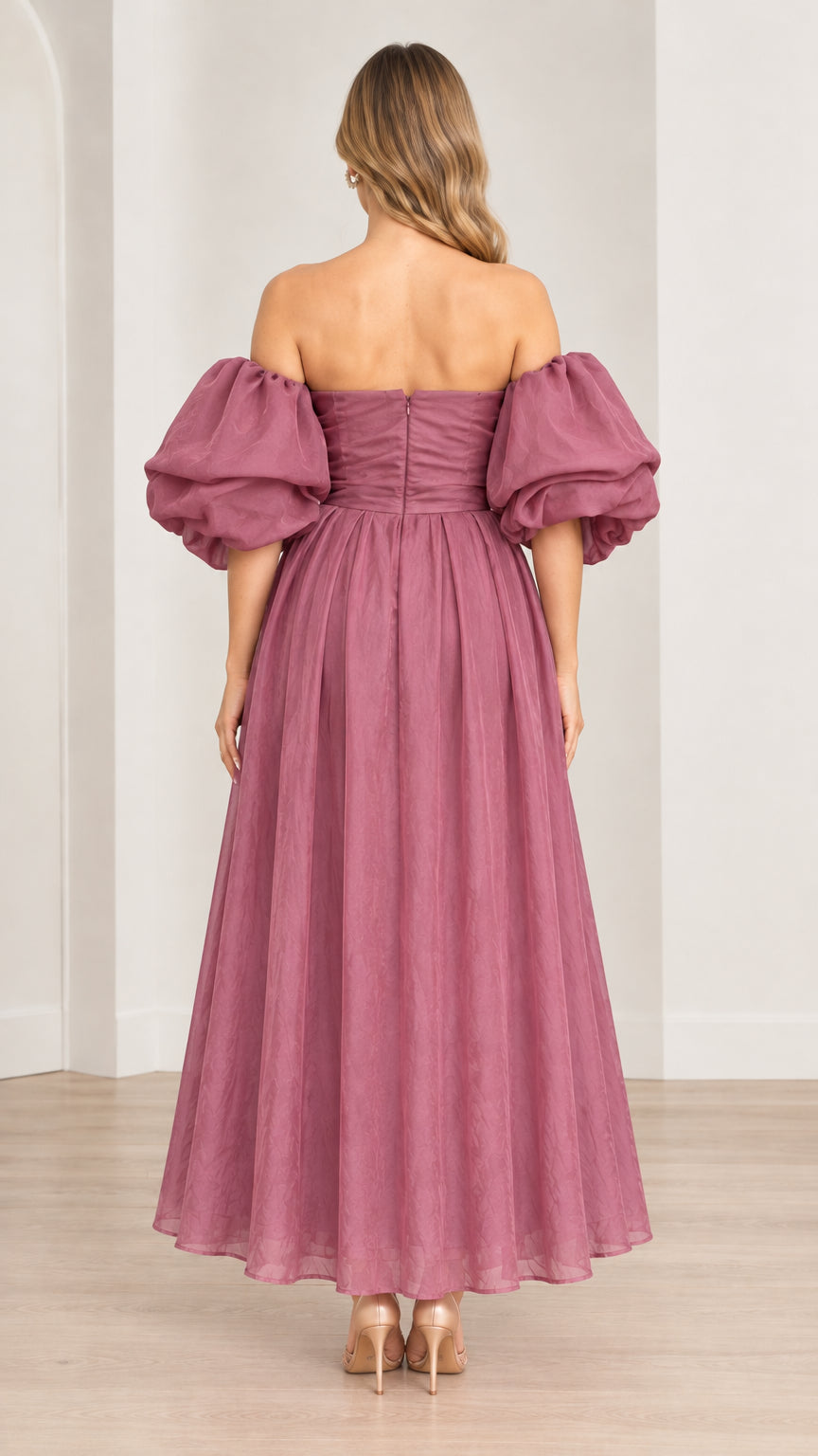 Rear view of model wearing mauve off-the-shoulder midi dress with back zipper detail