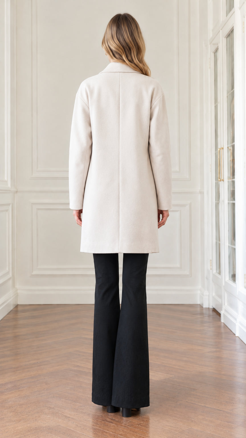 Back view of woman wearing cream open-front overcoat