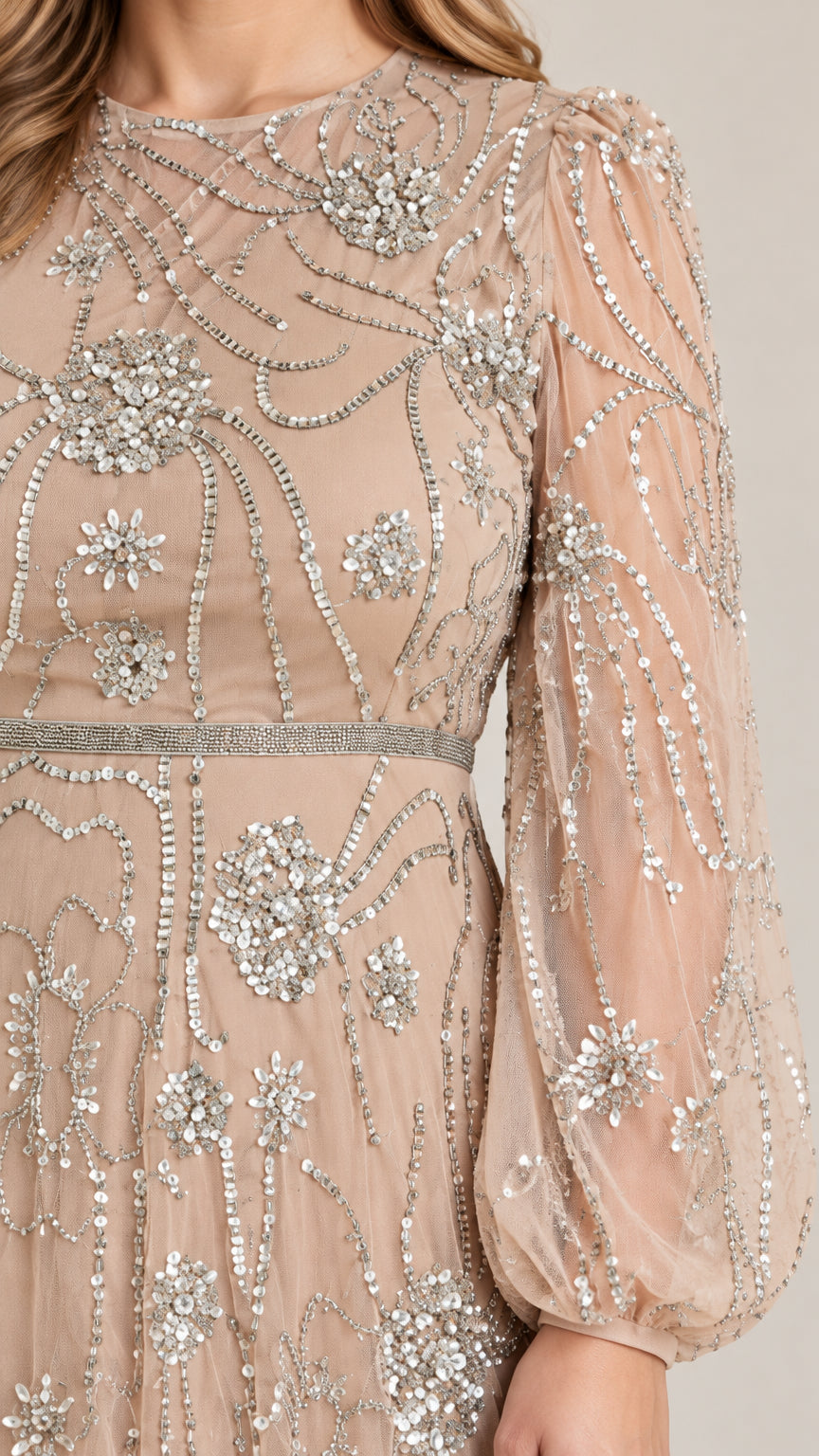 Close-up detail of champagne mesh fabric with intricate floral sequin embroidery
