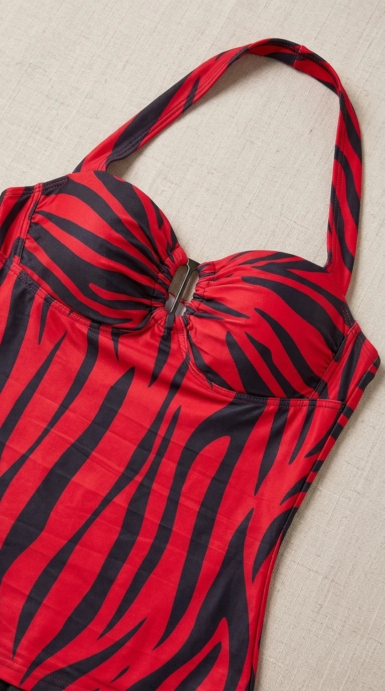 Close-up detail view of red zebra print halter top showing sweetheart bust line and metallic center hardware