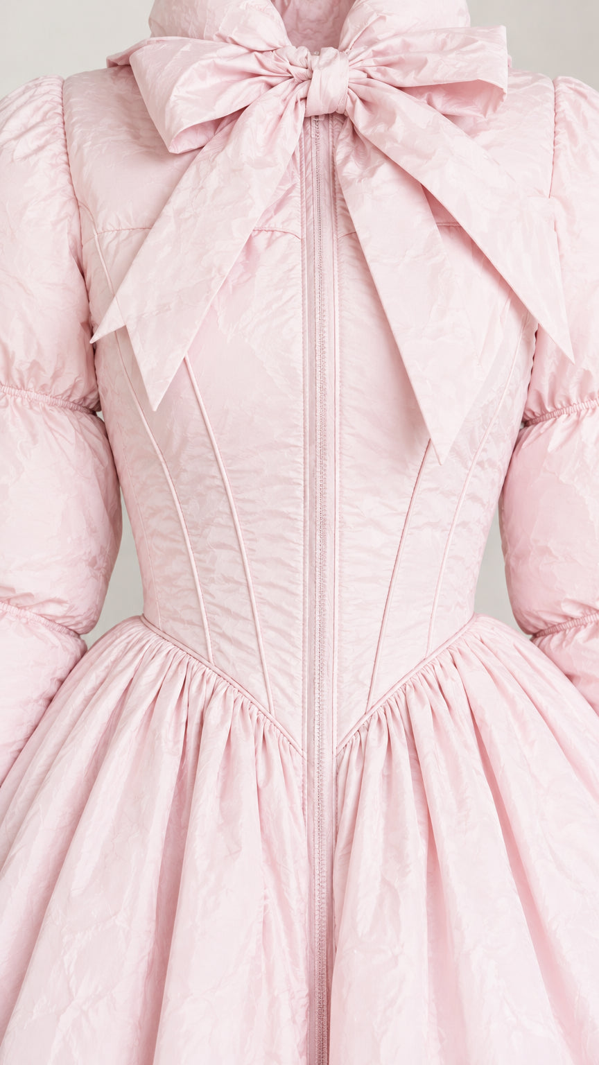 Close-up detail of the light pink coat bodice showing front zipper, corset seams, and bow collar
