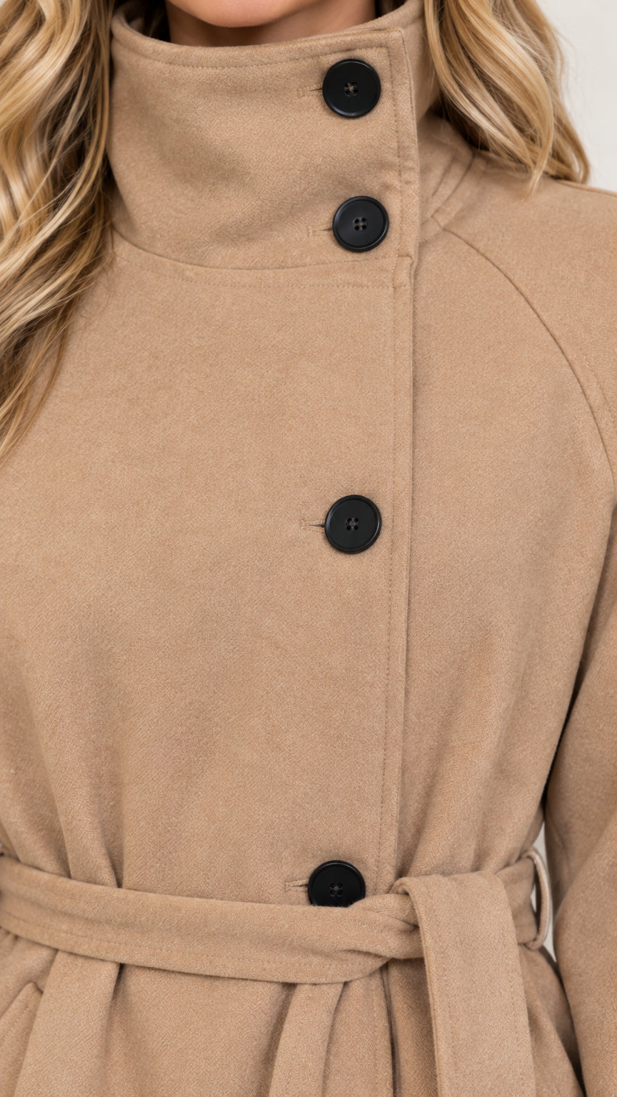 Close-up detail of high stand collar and front buttons on camel trench coat