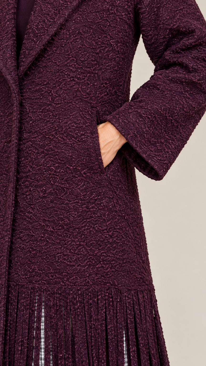 Close-up detail of burgundy bouclé fabric texture and side slip pocket