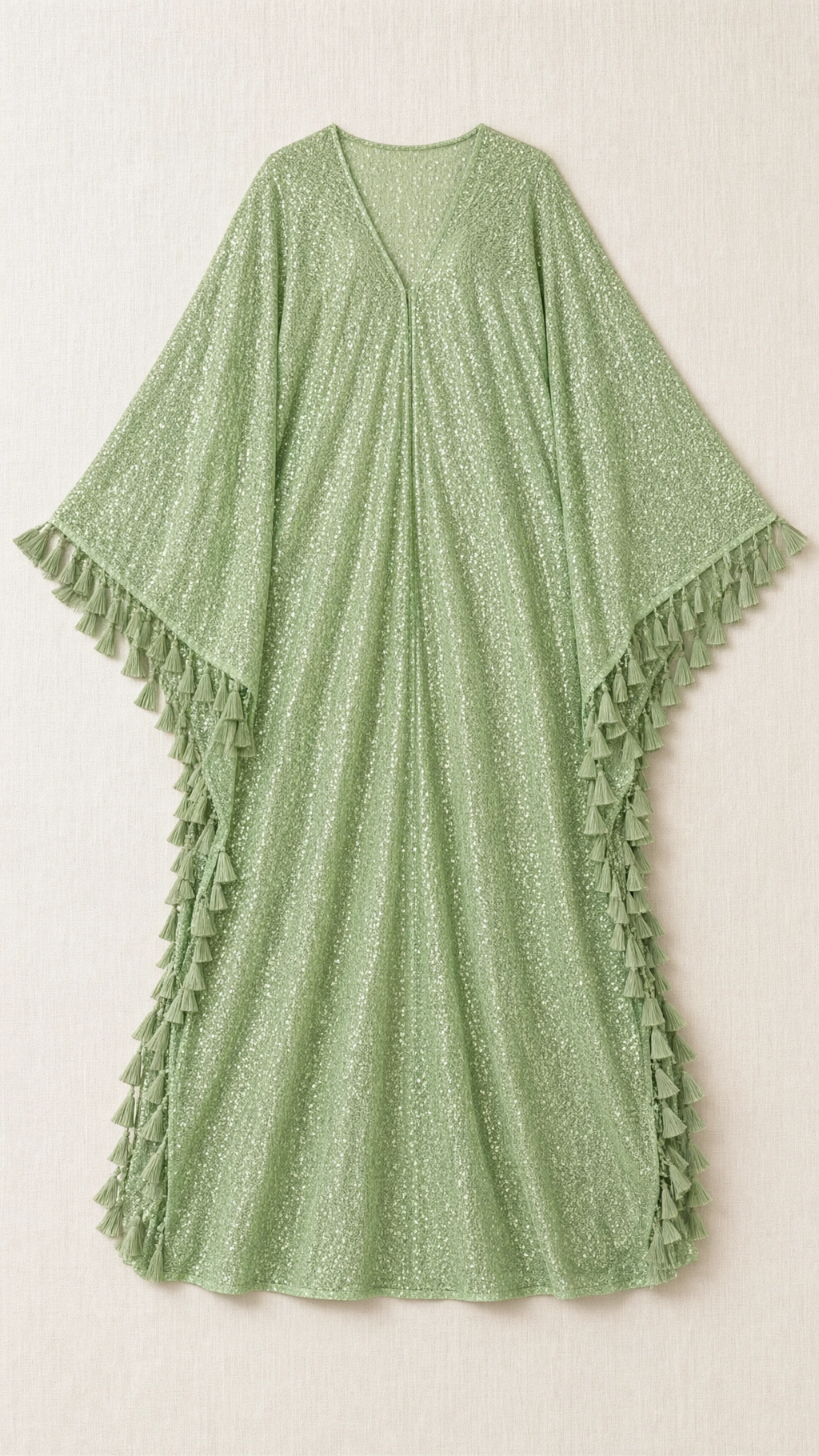 Flat lay of sage green sequin kaftan dress featuring wide sleeves and side fringe details