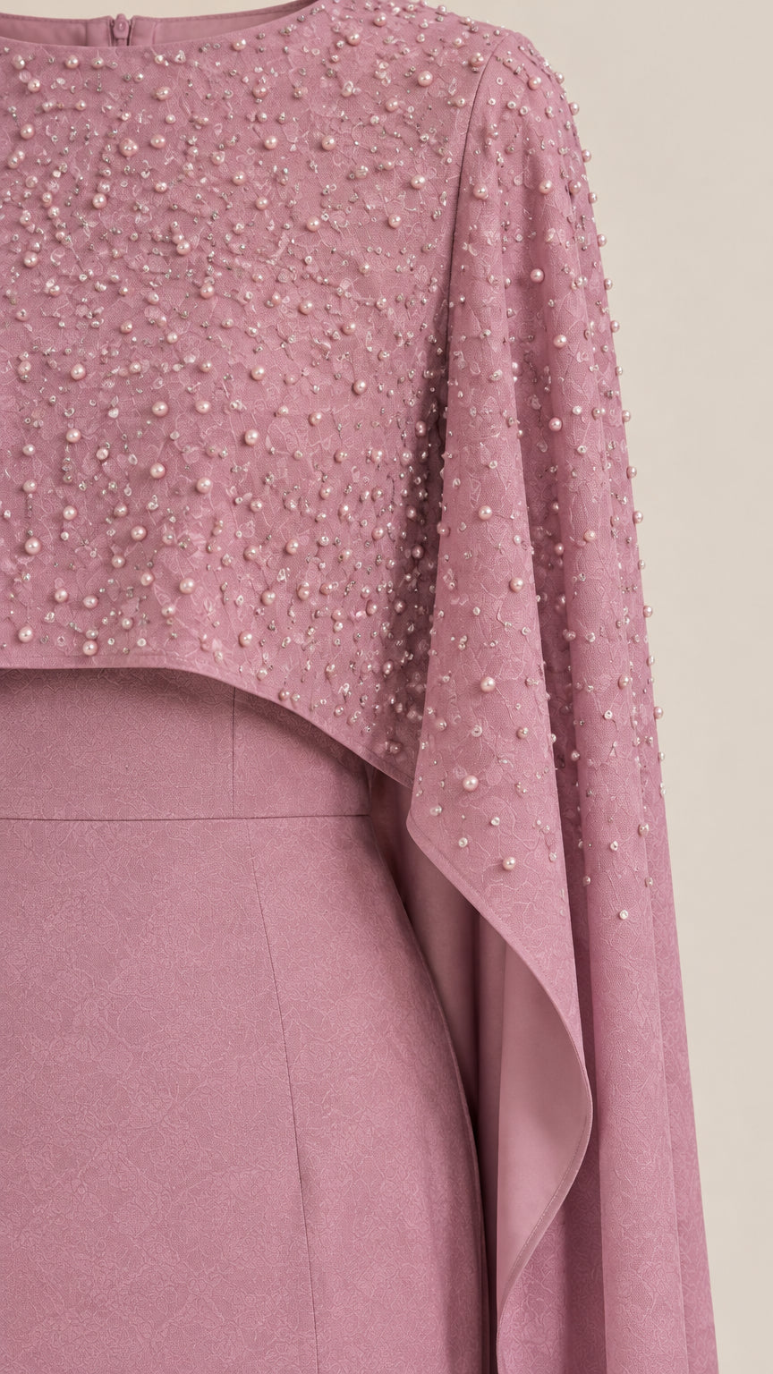 Close-up detail of pearl and bead embellishments on the cropped cape bodice