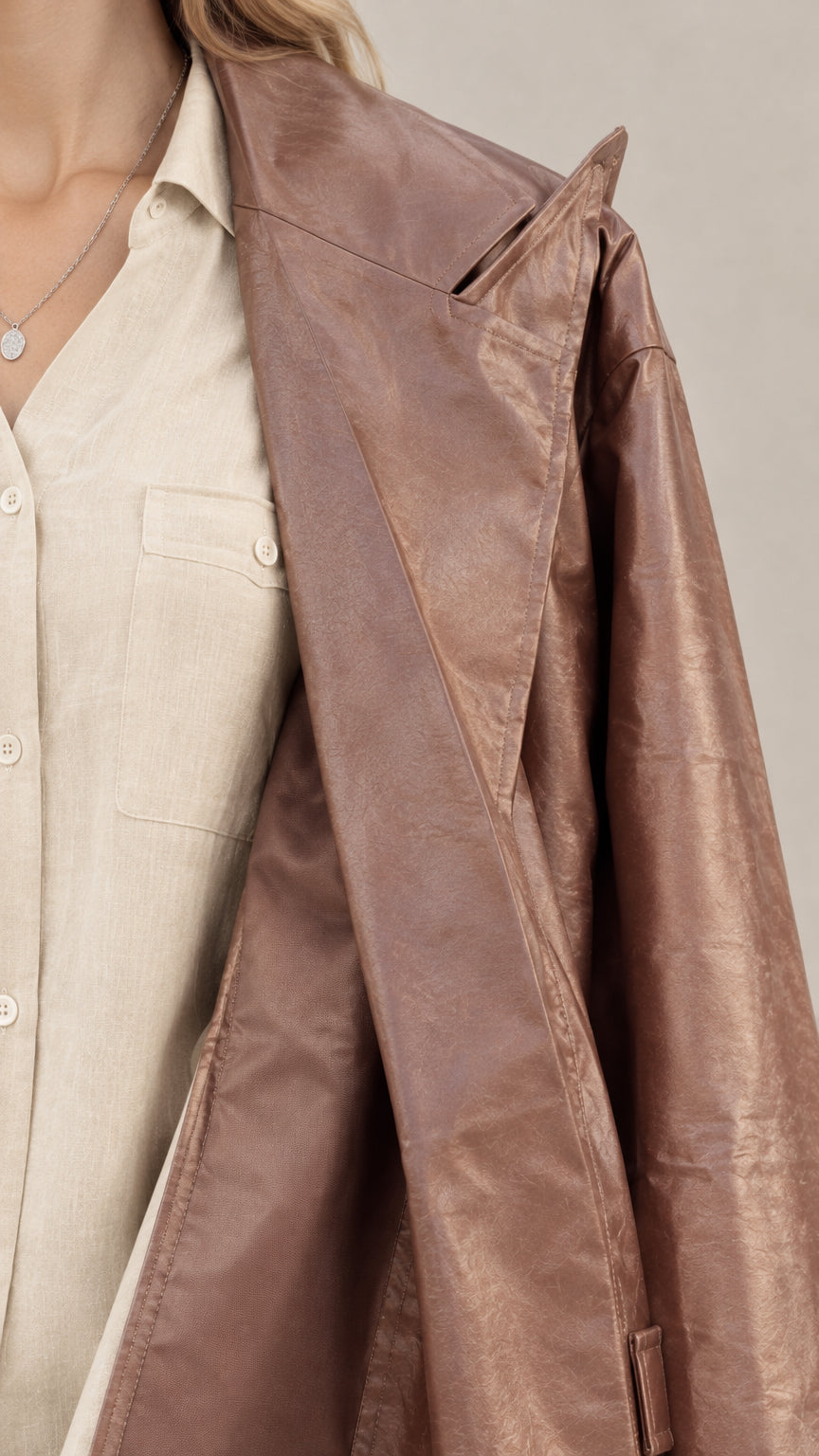 Close-up detail of the notched lapel duster coat and collared shirt fabric texture