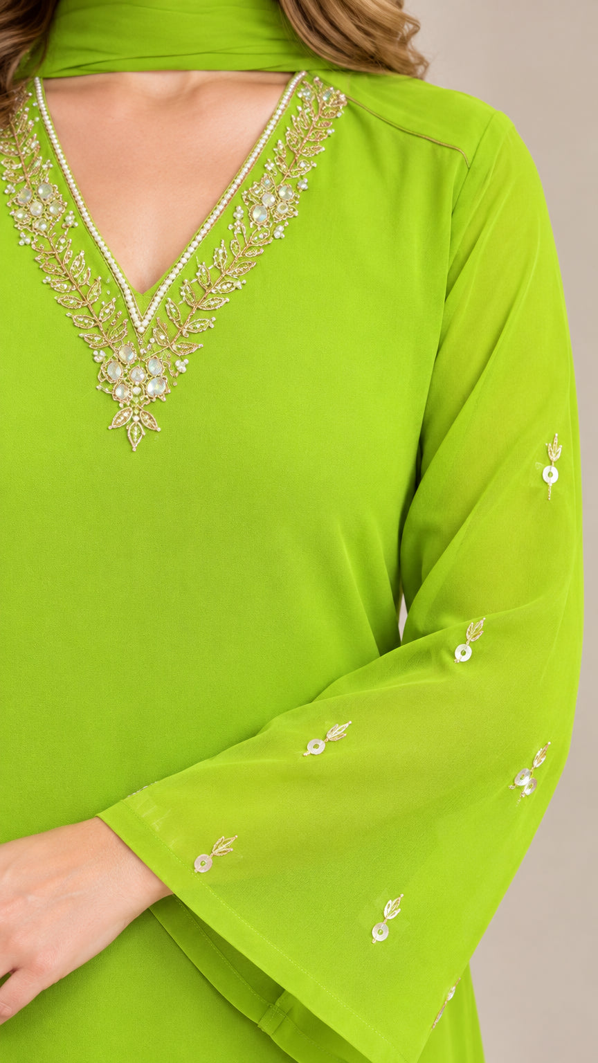 Close-up detail of embellished V-neckline with crystal and bead accents on lime green tunic