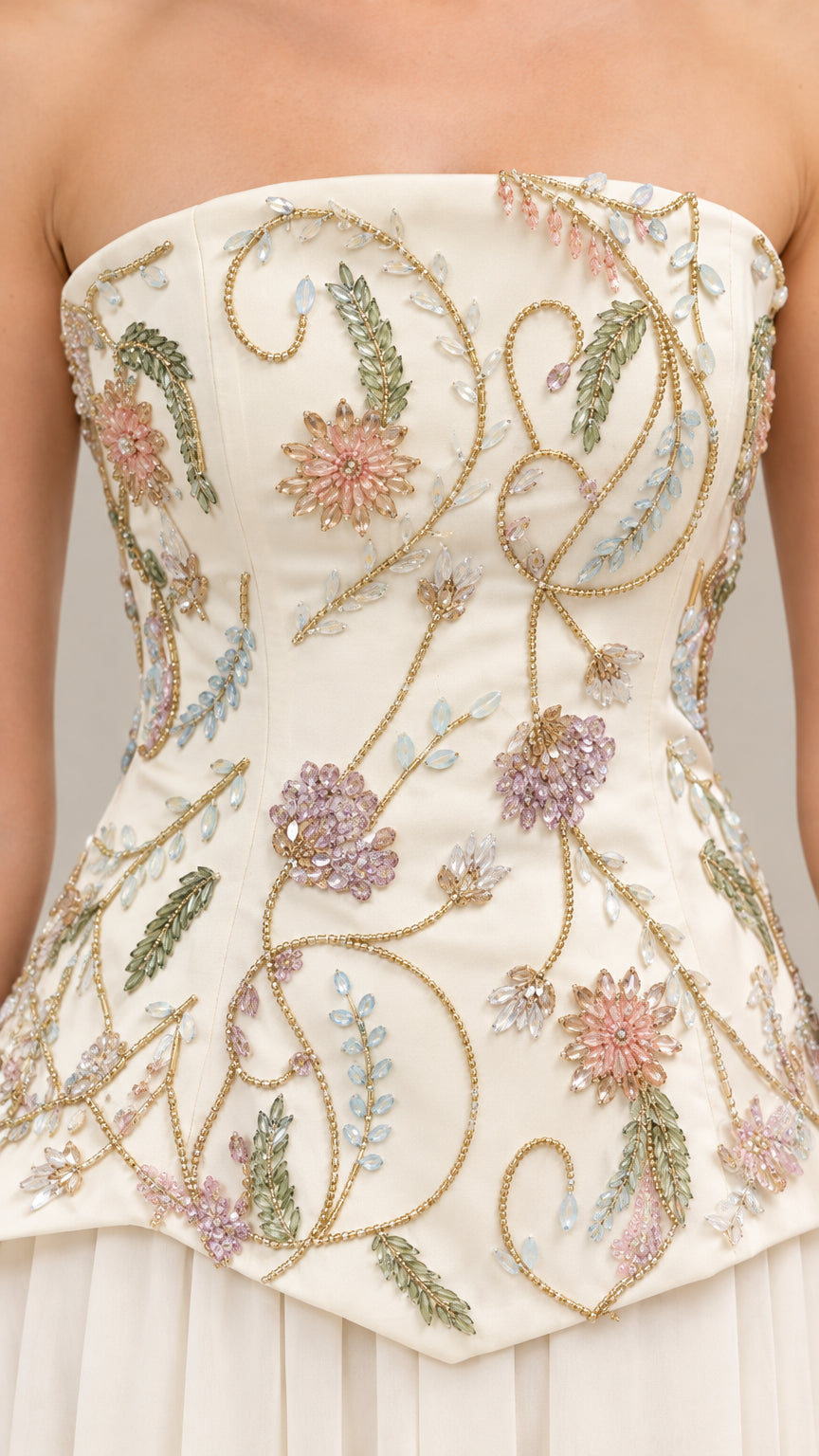 Close-up detail of botanical floral embroidery on ivory corset bodice