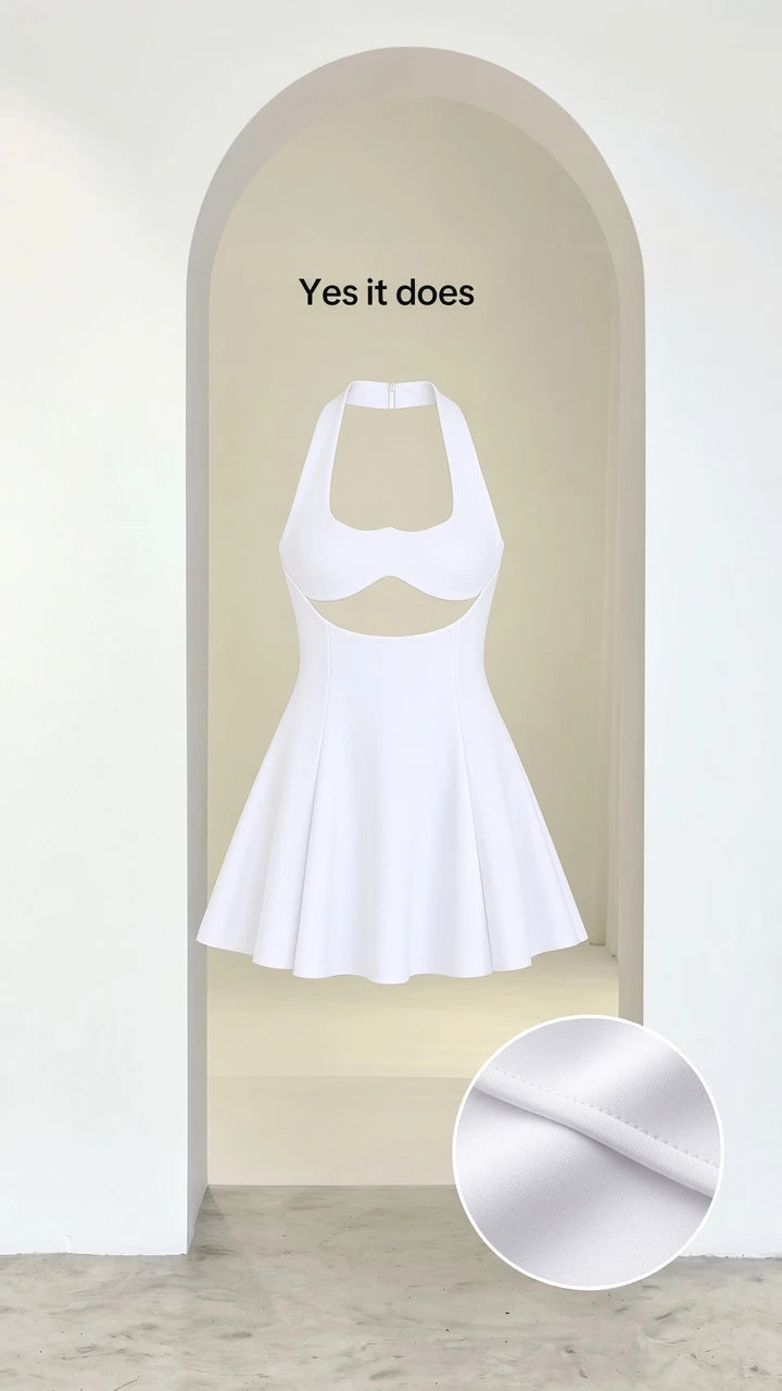 Studio display of white halter neck cutout mini dress with fabric texture detail