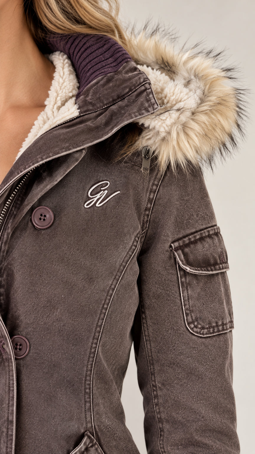 Close-up detail of faux fur hood, fleece collar, and sleeve pocket