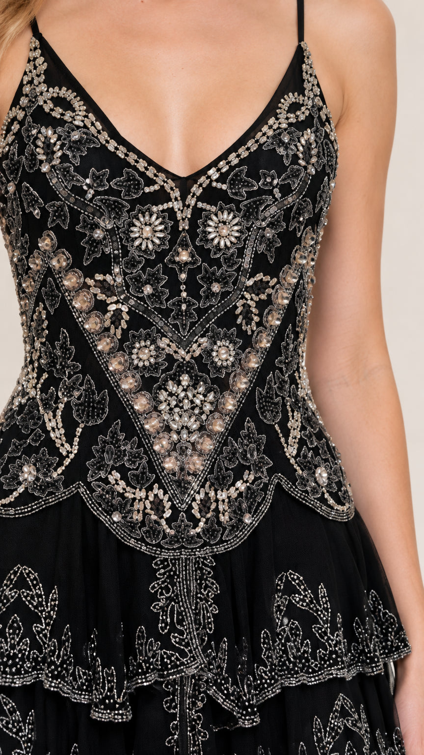 Close-up detail of intricate silver sequin and bead floral embroidery on black bodice