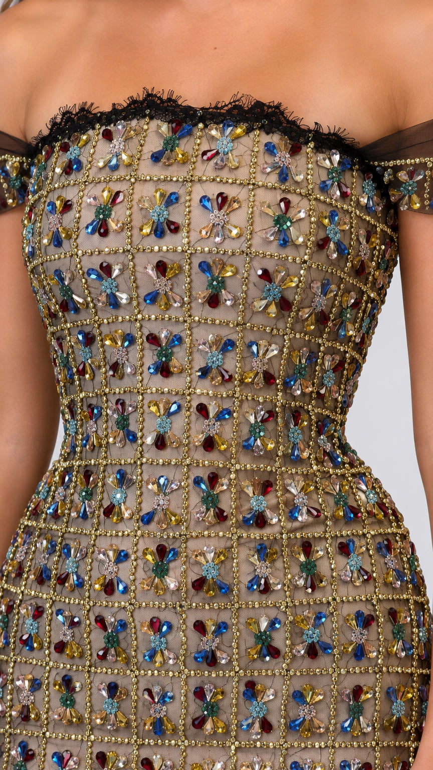 Close-up detail of off-the-shoulder lace trim and intricate multicolor floral crystal beading
