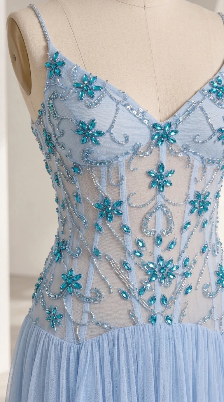 Close-up detail of light blue sheer bodice with turquoise floral crystal beading