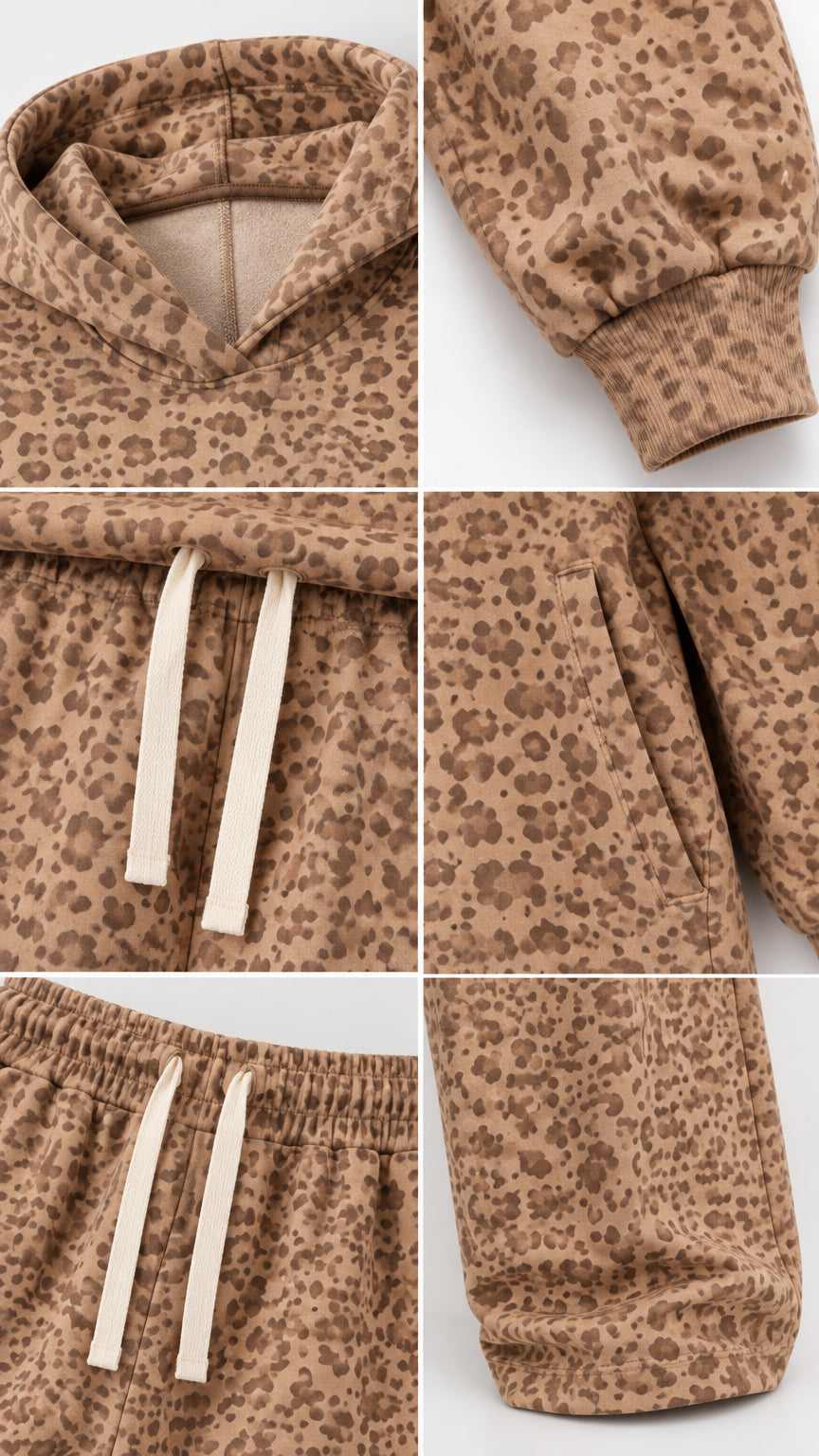 Close-up details of hood neckline, ribbed cuffs, drawstring waistband, side pockets, and wide-leg hem